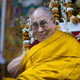 The Dalai Lama smiles as he sits on his chair at the Tsuglakhang temple in Dharmsala, India, Feb. 27, 2019.